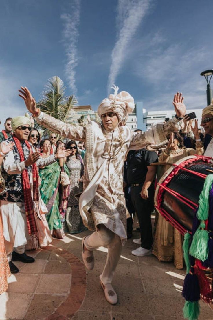Groom dancing beside the dhol at his Baraat