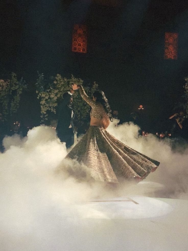 Bride twirling through low fog during her first dance