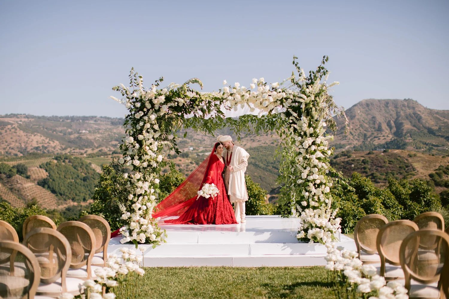 Couple under a floral mandap